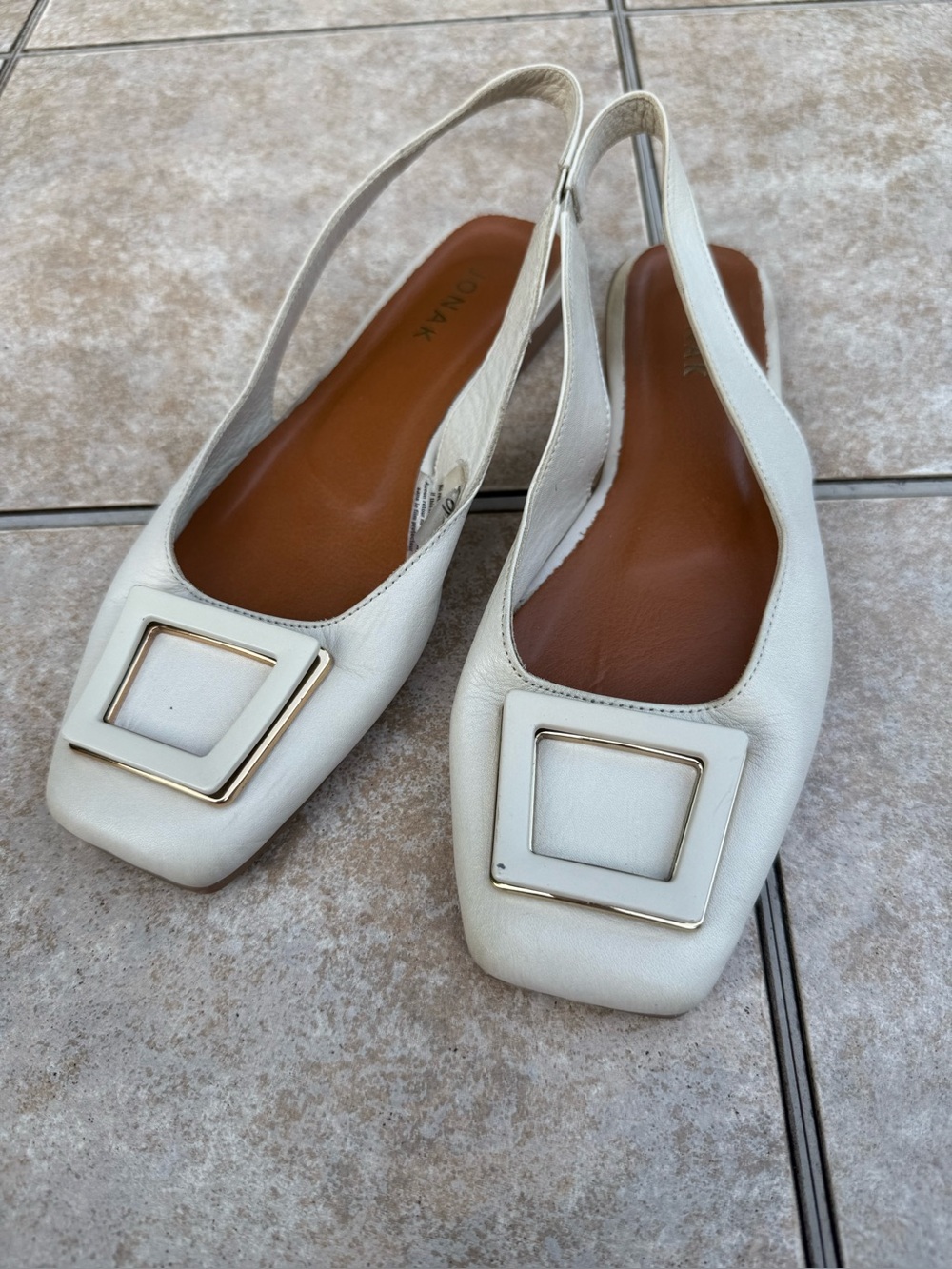 Jonak slingback flats feature a distinct square buckle detail on the toe